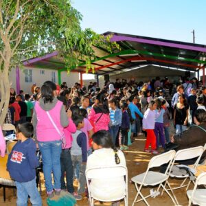 A lively gathering of children and adults at a community center in Mexico