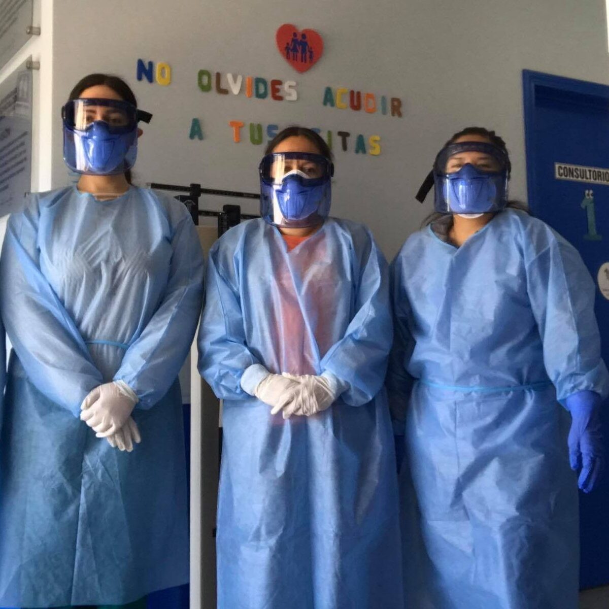 Four healthcare workers in blue protective gear standing inside a medical facility in Mexico